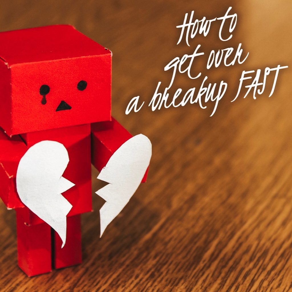 A little block-shaped robot made of paper holding a broken heart, also made of paper. Words next to it read "How to get over a breakup FAST."